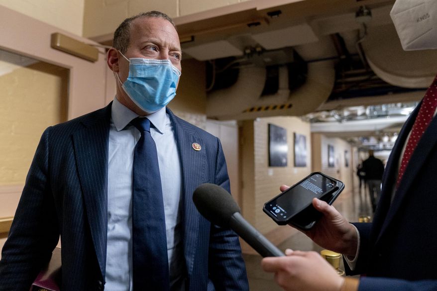 Rep. Josh Gottheimer, New Jersey Democrat, speaks to a reporter as he arrives for a meeting with House Democrats on Capitol Hill in Washington, Tuesday, Oct. 26, 2021. Moderate Democrats like Mr. Gottheimer are threatening to sink President Biden’s $1.75 trillion social welfare and climate bill unless he restores a federal income tax break that mostly benefits blue states. (AP Photo/Andrew Harnik)
