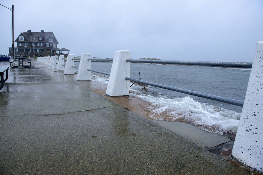 A rising tide churned by a nor&#39;easter breaches the seawall at Eastern Point, Tuesday, Oct. 26, 2021, in Groton, Conn. A powerful storm has begun barreling up the northeastern U.S. coast, and officials warn it could bring intense flooding and hurricane-force wind gusts. (Mark Mirko/Hartford Courant via AP)