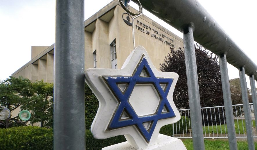 A Star of David hangs from a fence outside the dormant landmark Tree of Life synagogue in Pittsburgh&#x27;s Squirrel Hill neighborhood on Tuesday, Oct. 26, 2021, as the date marking the third year since 11 people were killed in America&#x27;s deadliest antisemitic attack on Oct. 27, 2018, approaches. (AP Photo/Gene J. Puskar)