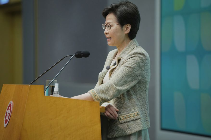 Hong Kong Chief Executive Carrie Lam wearing an arm brace after suffering fracture from fall at home, speaks during a press conference in Hong Kong, Tuesday, Oct. 26, 2021. Hong Kong will tighten COVID-19 restrictions despite a lack of local outbreaks to better align with China’s policies and increase chances of quarantine-free travel between the territory and mainland, Lam said. (AP Photo/Kin Cheung)