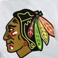 In this May 3, 2021, file photo, the Chicago Blackhawks logo is displayed on a jersey in Raleigh, N.C. The Blackhawks are holding a briefing Tuesday, Oct. 26, 2021, to discuss the findings of an investigation into allegations that an assistant coach sexually assaulted a player in 2010.  (AP Photo/Karl B DeBlaker, File)