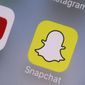 FILE- This Aug. 9, 2017, file photo shows the Youtube, left, and Snapchat apps on a mobile device in New York. The leaders of a Senate panel have called executives from YouTube, TikTok and Snapchat to face questions on what the companies are doing to ensure young users’ safety. The hearing Tuesday, Oct. 26, 2021, comes as the panel bears down on hugely popular social media platforms and their impact on children.  (AP Photo/Richard Drew, File)