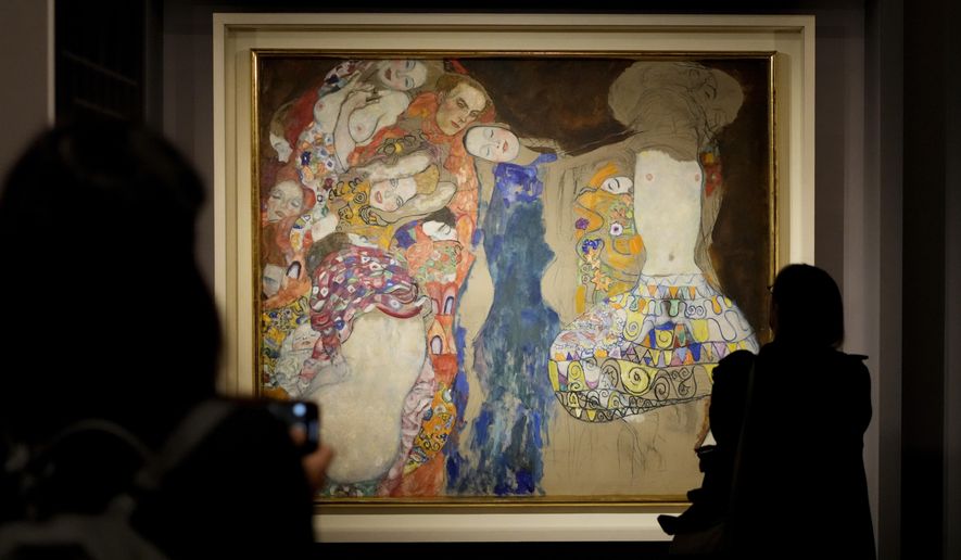 People admire Gustav Klimt&#x27;s oil on canvas painting &amp;quot;The Bride&amp;quot; (1918) on display at the exhibition &amp;quot;Klimt. The Secession and Italy&amp;quot; at the Museum of Rome, in Palazzo Braschi, Rome, during a press preview, Tuesday, Oct. 26, 2021. The exhibition, that explores Klimt&#x27;s period in Italy, will be open to visitors from Oct.27, 2021 to March 27, 2022. (AP Photo/Andrew Medichini)