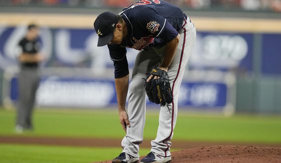 Atlanta Braves starting pitcher Charlie Morton rubs his leg before leaving the game during the third inning of Game 1 in baseball&#39;s World Series between the Houston Astros and the Atlanta Braves Tuesday, Oct. 26, 2021, in Houston. (AP Photo/Ashley Landis)