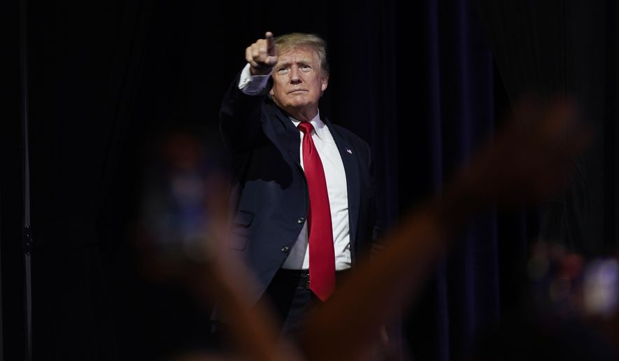 In this July 24, 2021, file photo, former President Donald Trump points to supporters after speaking at a Turning Point Action gathering, in Phoenix. Mr. Trump celebrated the news on Oct. 29 that GOP Rep. Adam Kinzinger won&#x27;t be seeking re-election.&quot;2 down, 8 to go!&quot; Mr. Trump said in a statement, referring to the 10 GOP lawmakers who voted to impeach the former president after the Jan. 6 Capitol riot. (AP Photo/Ross D. Franklin, File)