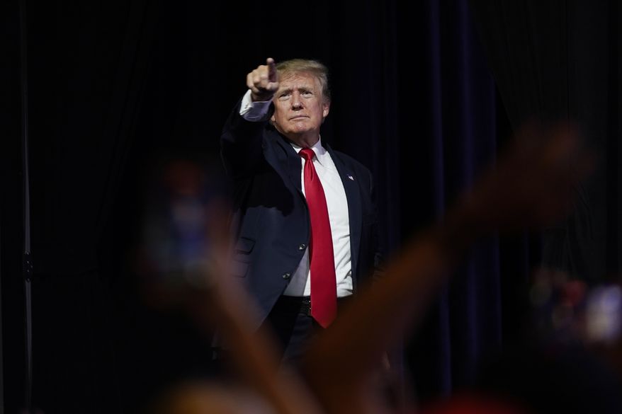 In this July 24, 2021, file photo, former President Donald Trump points to supporters after speaking at a Turning Point Action gathering, in Phoenix. Mr. Trump celebrated the news on Oct. 29 that GOP Rep. Adam Kinzinger won&#39;t be seeking re-election.&quot;2 down, 8 to go!&quot; Mr. Trump said in a statement, referring to the 10 GOP lawmakers who voted to impeach the former president after the Jan. 6 Capitol riot. (AP Photo/Ross D. Franklin, File)