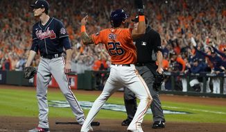 Houston Astros&#x27; Jose Siri celebrates past Atlanta Braves starting pitcher Max Fried on a throwing error during the second inning in Game 2 of baseball&#x27;s World Series between the Houston Astros and the Atlanta Braves Wednesday, Oct. 27, 2021, in Houston. (AP Photo/Eric Gay)