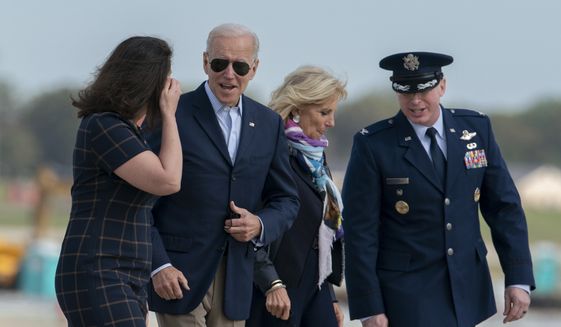 President Joe Biden and first lady Jill Biden speak with Sarb Edmund, 89th Airlift Wing Senior/Training Protocol Specialist, and Col. William &quot;Chris&quot; McDonald, the Vice Commander of the 89th Airlift Wing, as they walk to board Air Force One for a trip to Rome to attend the G-20 meeting, Thursday, Oct. 28, 2021, in Andrews Air Force Base, Md. . (AP Photo/Gemunu Amarasinghe)