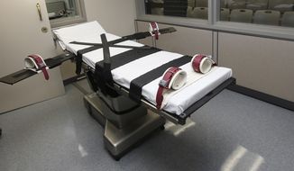 FILE - This Oct. 9, 2014, file photo shows the gurney in the the execution chamber at the Oklahoma State Penitentiary in McAlester, Okla. A 60-year-old Oklahoma man who stabbed a prison cafeteria worker to death in 1998 is scheduled to receive a lethal injection Thursday, Oct. 28, 2021 in the state&#39;s first attempt to administer the death penalty since a series of flawed executions more than six years ago. The state was moving forward with John Marion Grant&#39;s lethal injection after the U.S. Supreme Court, in a 5-3 decision, lifted stays of execution that were put in place on Wednesday for Grant and another death row inmate, Julius Jones, by the 10th U.S. Circuit Court of Appeals. (AP Photo/Sue Ogrocki, File)