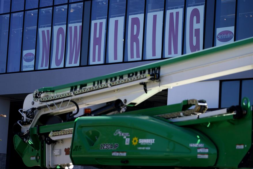 A hiring sign is displayed at a furniture store window on Friday, Sept. 17, 2021, in Downers Grove, Ill. Unemployment claims dropped 6,000 to 290,000 last week, the third straight drop, the Labor Department said Thursday, Oct. 21, 2021,. That’s the fewest people to apply for benefits since March 14, 2020, when the pandemic intensified. (AP Photo/Nam Y. Huh)