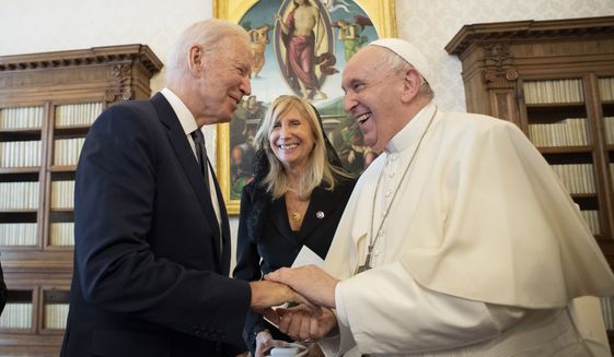 US President Joe Biden, left, shakes hands with Pope Francis as they meet at the Vatican, Friday, Oct. 29, 2021. (Vatican Media via AP)
