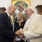 US President Joe Biden, left, shakes hands with Pope Francis as they meet at the Vatican, Friday, Oct. 29, 2021. President Joe Biden is set to meet with Pope Francis on Friday at the Vatican, where the worlds two most notable Roman Catholics plan to discuss the COVID-19 pandemic, climate change and poverty. The president takes pride in his Catholic faith, using it as moral guidepost to shape many of his social and economic policies. (Vatican Media via AP)