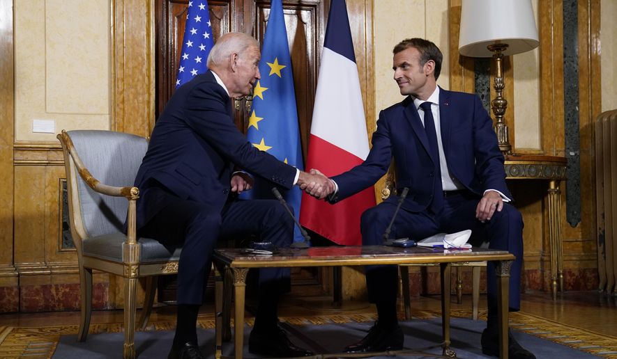 U.S. President Joe Biden, left, and French President Emmanuel Macron shake hands during a meeting at La Villa Bonaparte in Rome, Friday, Oct. 29, 2021. A Group of 20 summit scheduled for this weekend in Rome is the first in-person gathering of leaders of the world&#39;s biggest economies since the COVID-19 pandemic started. (AP Photo/Evan Vucci)