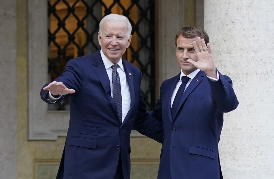 U.S. President Joe Biden, left, and French President Emmanuel Macron wave prior to a meeting at La Villa Bonaparte in Rome, Friday, Oct. 29, 2021. A Group of 20 summit scheduled for this weekend in Rome is the first in-person gathering of leaders of the world&#39;s biggest economies since the COVID-19 pandemic started. (AP Photo/Evan Vucci)