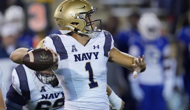Navy quarterback Tai Lavatai (1) throws in the first half of an NCAA college football game against Tulsa, Friday, Oct. 29, 2021, in Tulsa, Okla. (AP Photo/Sue Ogrocki)