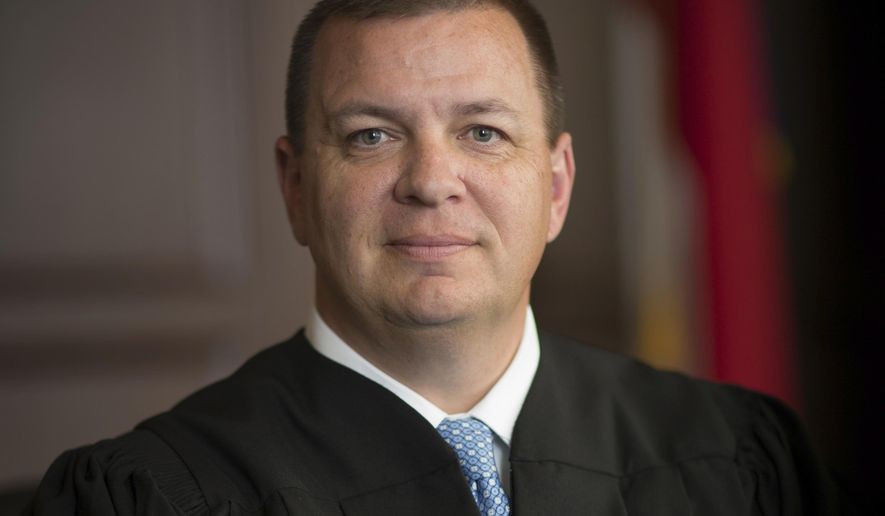 This photo provided by North Carolina Administrative Office of the Courts shows Associate Justice Phil Berger Jr.  One of several legal challenges to North Carolina’s contentious voter ID law is on hold amid a dispute over whether two justices on the state Supreme Court — one the son of arguably the state&#39;s most powerful Republican politician — should recuse themselves. (North Carolina Administrative Office of the Courts via AP)