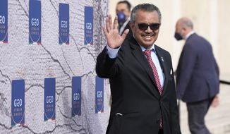 World Health Organisation Tedros Adhanom Ghebreyesus waves as he arrives for a meeting of G20 finance and health ministers at the Salone delle Fontane (Hall of Fountains) in Rome, Friday, Oct. 29, 2021. The World Health Organization says its director-general, Tedros Adhanom Ghebreyesus, is running unopposed for a second five-year term. The U.N. health agency made the announcement Friday after the deadline for candidacies for the next five-year term expired on Sept. 23. (AP Photo/Alessandra Tarantino)