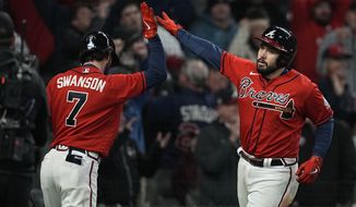 Atlanta Braves&#39; Travis d&#39;Arnaud celebrates his home run with Dansby Swanson during the eighth inning in Game 3 of baseball&#39;s World Series between the Houston Astros and the Atlanta Braves Friday, Oct. 29, 2021, in Atlanta. (AP Photo/Brynn Anderson)