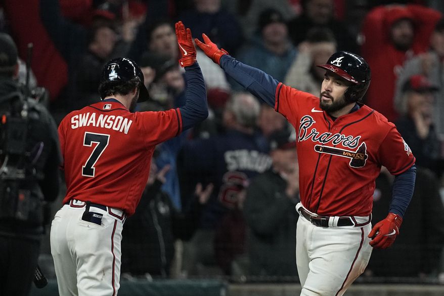 Atlanta Braves&#39; Travis d&#39;Arnaud celebrates his home run with Dansby Swanson during the eighth inning in Game 3 of baseball&#39;s World Series between the Houston Astros and the Atlanta Braves Friday, Oct. 29, 2021, in Atlanta. (AP Photo/Brynn Anderson)