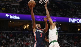Washington Wizards guard Bradley Beal (3) goes to the basket against Boston Celtics forward Jabari Parker, right, during the second half of an NBA basketball game, Saturday, Oct. 30, 2021, in Washington. The Wizards won 115-112 in double overtime. (AP Photo/Nick Wass)