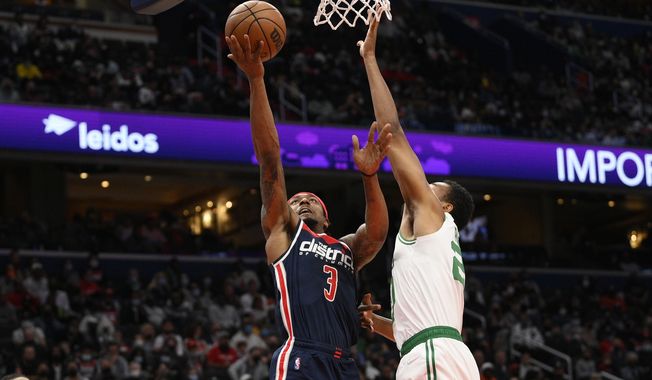 Washington Wizards guard Bradley Beal (3) goes to the basket against Boston Celtics forward Jabari Parker, right, during the second half of an NBA basketball game, Saturday, Oct. 30, 2021, in Washington. The Wizards won 115-112 in double overtime. (AP Photo/Nick Wass)