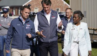 Republican gubernatorial candidate Glenn Youngkin, center, speaks with running mates, Attorney General candidate, Jason Miyares, left, and Lt. Gov candidate Winsome Sears, right, as they walk from a rally in Fredericksburg, Va., Saturday, Oct. 30, 2021. Youngkin will face Democrat former Gov. Terry McAuliffe in the November election. (AP Photo/Steve Helber)