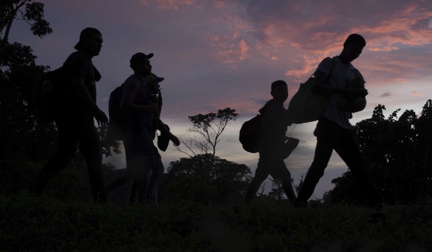 Migrants leave Ulapa, Chiapas state, late Saturday, Oct. 30, 2021. The migrant caravan heading north in southern Mexico has so far been allowed to walk unimpeded, a change from the Mexican government&#39;s reaction to other attempted mass migrations. (AP Photo/Isabel Mateos)