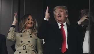 Former President Donald Trump and his wife Melania perform the tomahawk chop before Game 4 of baseball&#x27;s World Series between the Houston Astros and the Atlanta Braves Saturday, Oct. 30, 2021, in Atlanta. (AP Photo/David J. Phillip)