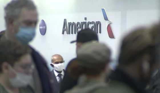 People wait in line at an American Airlines counter at an airport in Charlotte, N.C. on Sunday, Oct. 31, 2021. The airline has canceled more than 800 flights on Sunday, or nearly 30% of its schedule for the day. (WSOC-TV via AP)