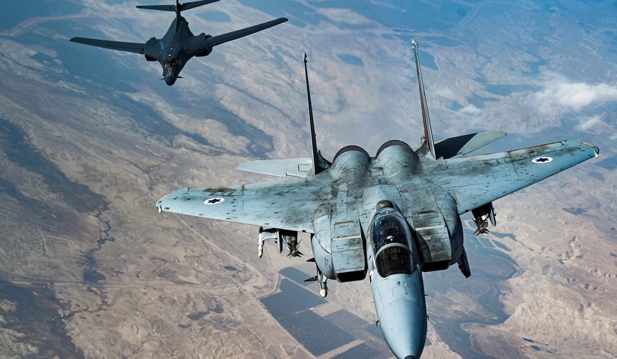 In this photo released by the U.S. Air Force, an Israeli Air Force F-15 Strike Eagle flies in formation with a U.S. Air Force B-1B Lancer over Israel as part of a deterrence flight Saturday, Oct. 30, 2021. Members of the Air Force and Space Force will now be able to tell others what pronouns they use in official correspondence under a just-adopted diversity policy change endorsed by the senior brass. (U.S. Air Force/Senior Airman Jerreht Harris via AP)