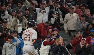 Fans cheer after Houston Astros&#39; Michael Brantley strikes out for the last out during the ninth inning in Game 4 of baseball&#39;s World Series between the Houston Astros and the Atlanta Braves Saturday, Oct. 30, 2021, in Atlanta. (AP Photo/David J. Phillip)