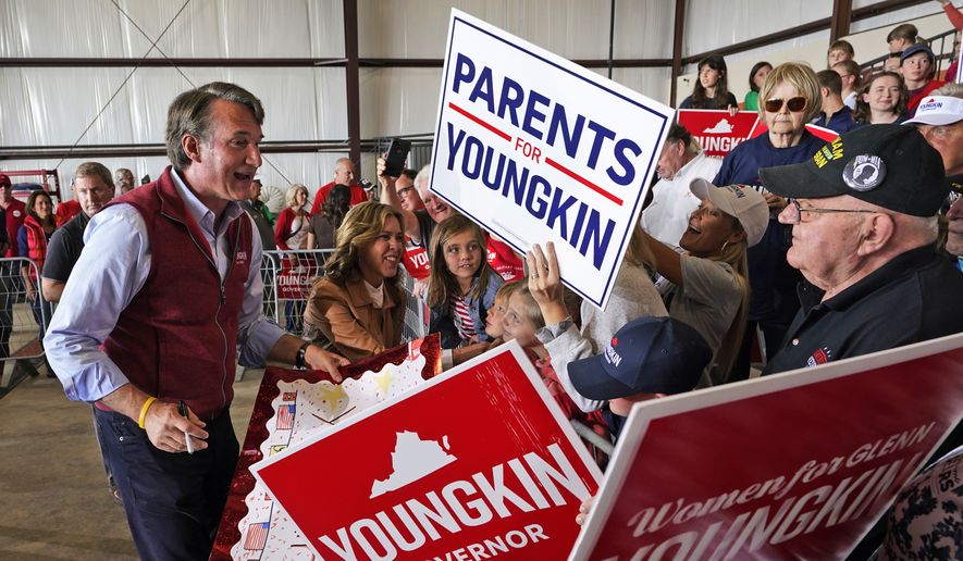 Republican gubernatorial candidate Glenn Youngkin , left, and his wife Suzanne, second from left, greet supporters during a rally in Chesterfield, Va., Monday, Nov. 1, 2021. Youngkin will face Democrat former Gov. Terry McAuliffe in the November election. (AP Photo/Steve Helber)