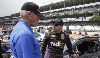 NASCAR team owner Joe Gibbs, left, talks with Denny Hamlin before the Brickyard 400 auto race at Indianapolis Motor Speedway in Indianapolis, July 27, 2014. Long recognized alongside Mark Martin as the greatest NASCAR driver to never win a championship, Hamlin has a fifth try Sunday to at long last grab that elusive Cup title.  (AP Photo/Darron Cummings, File) **FILE**
