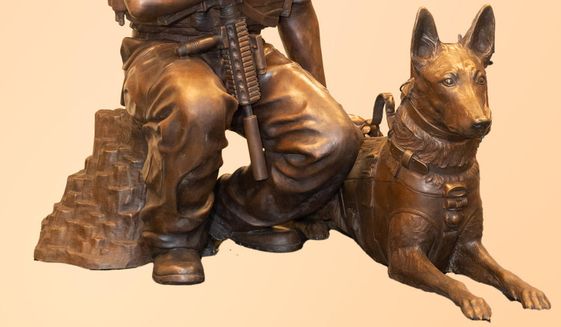 Navy SEAL John Douangdara and his Belgian Malinois war dog, Bart, are depicted in a larger-than-life bronze statue that the U.S. Navy Memorial will unveil on Veterans Day. (Jeff Malet/U.S. Navy Memorial)
