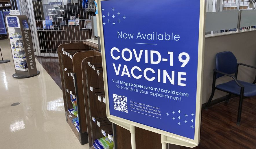 In this Saturday, Oct. 23, 2021, photograph, a sign notifies customers that COVID-19 vaccinations are available at a pharmacy in a grocery store in Monument, Colo. Companies with at least 100 workers will be required to give employees paid time off to get vaccinated against COVID-19 and paid sick leave if they have side effects from the shots. That&#x27;s according to a Biden administration official who spoke Monday, Nov. 1,  about pending vaccine-mandate rules from OSHA, the Occupational Safety and Health Administration. (AP Photo/David Zalubowski) **FILE**