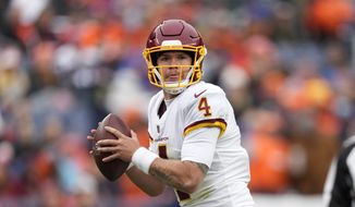 Washington Football Team quarterback Taylor Heinicke (4) against the Denver Broncos during the first half of an NFL football game, Sunday, Oct. 31, 2021, in Denver. (AP Photo/David Zalubowski) **FILE**