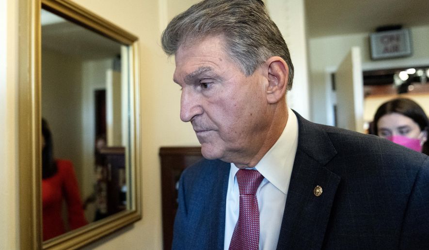 Sen. Joe Manchin, D-W.Va., departs after speaking with reporters during a news conference on Capitol Hill, Monday, Nov. 1, 2021 in Washington. (AP Photo/Alex Brandon)