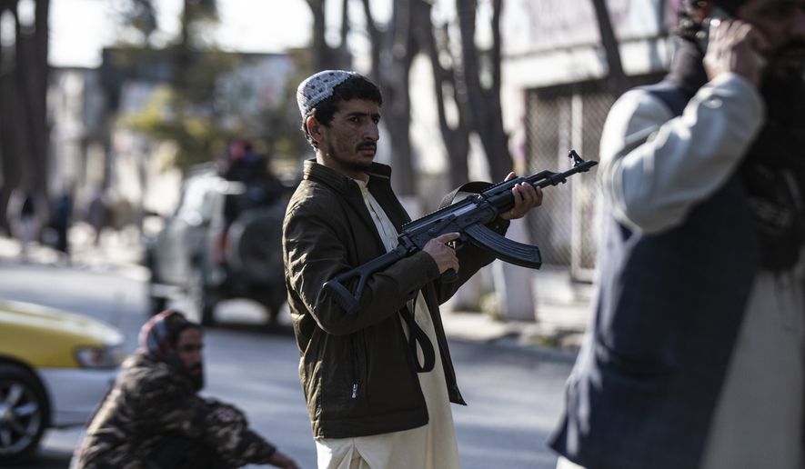 Taliban fighters block roads after an explosion Tuesday, Nov. 2, 2021. An explosion went off Tuesday at the entrance of a military hospital in Kabul, killing several people and wounding over a dozen, health officials said. (AP Photo/Ahmad Halabisaz)