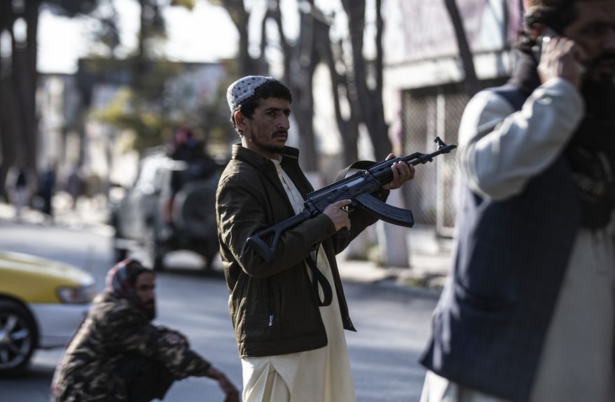 Taliban fighters block roads after an explosion Tuesday, Nov. 2, 2021. An explosion went off Tuesday at the entrance of a military hospital in Kabul, killing several people and wounding over a dozen, health officials said. (AP Photo/Ahmad Halabisaz)