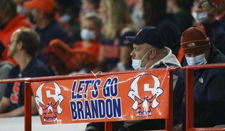 A banner reading &quot;Let&#39;s go Brandon&quot; is seen on the railing during the first half of an NCAA college football game between Boston College and Syracuse in Syracuse, N.Y., Saturday, Oct. 30, 2021. (AP Photo/Joshua Bessex)