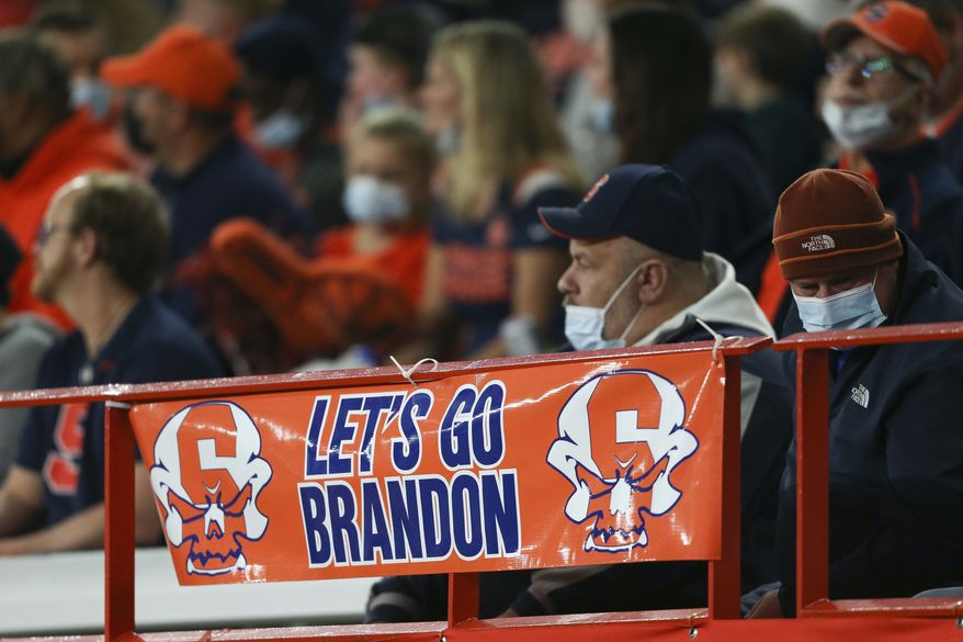 A banner reading &quot;Let&#x27;s go Brandon&quot; is seen on the railing during the first half of an NCAA college football game between Boston College and Syracuse in Syracuse, N.Y., Saturday, Oct. 30, 2021. (AP Photo/Joshua Bessex)