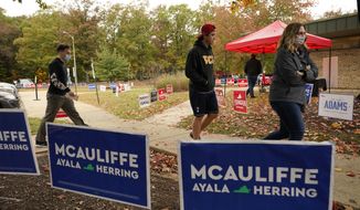 Voters head to the polls at a school in Midlothian, Va., Tuesday, Nov. 2, 2021. Voters are deciding between Democrat Terry McAuliffe and Republican Glenn Youngkin for Governor. (AP Photo/Steve Helber)