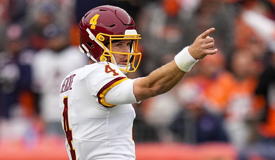 Washington Football Team quarterback Taylor Heinicke (4) signals a first down against the Denver Broncos during an NFL football game Sunday, Oct. 31, 2021, in Denver. (AP Photo/Jack Dempsey)