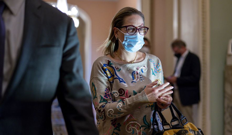 Sen. Kyrsten Sinema, D-Ariz., walks to the chamber after a Senate Democratic Caucus meeting at the Capitol in Washington, Tuesday, Nov. 2, 2021. Sinema, a key holdout on President Joe Biden&#39;s social agenda, reached a deal with Senate Majority Leader Chuck Schumer on a plan to lower prescription drug costs for older people, capping out-of-pocket Medicare costs at $2,000 and reducing the price of insulin. (AP Photo/J. Scott Applewhite)