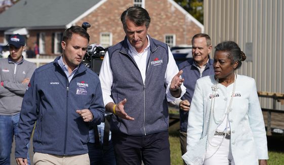 Republican gubernatorial candidate Glenn Youngkin, center, speaks with running mates, attorney general candidate, Jason Miyares, left, and lieutenant governor candidate Winsome Sears, right, as they walk from a rally in Fredericksburg, Va., Saturday, Oct. 30, 2021. Youngkin will face Democrat former Gov. Terry McAuliffe in the November election. (AP Photo/Steve Helber, File)