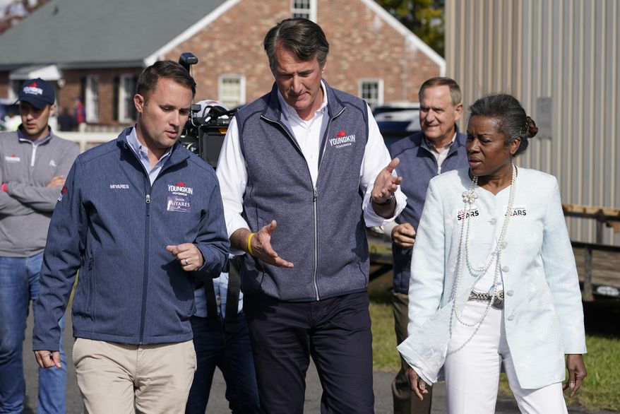 Republican gubernatorial candidate Glenn Youngkin, center, speaks with running mates, attorney general candidate, Jason Miyares, left, and lieutenant governor candidate Winsome Sears, right, as they walk from a rally in Fredericksburg, Va., Saturday, Oct. 30, 2021. Youngkin will face Democrat former Gov. Terry McAuliffe in the November election. (AP Photo/Steve Helber, File)