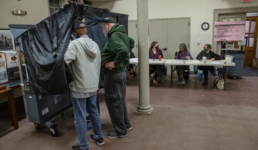 Poll workers prepare the voting machines for the start of voting on Election Day at Falls of Schuylkill Branch of Free Library in Philadelphia, Tuesday, Nov. 2, 2021. (Alejandro A. Alvarez/The Philadelphia Inquirer via AP)