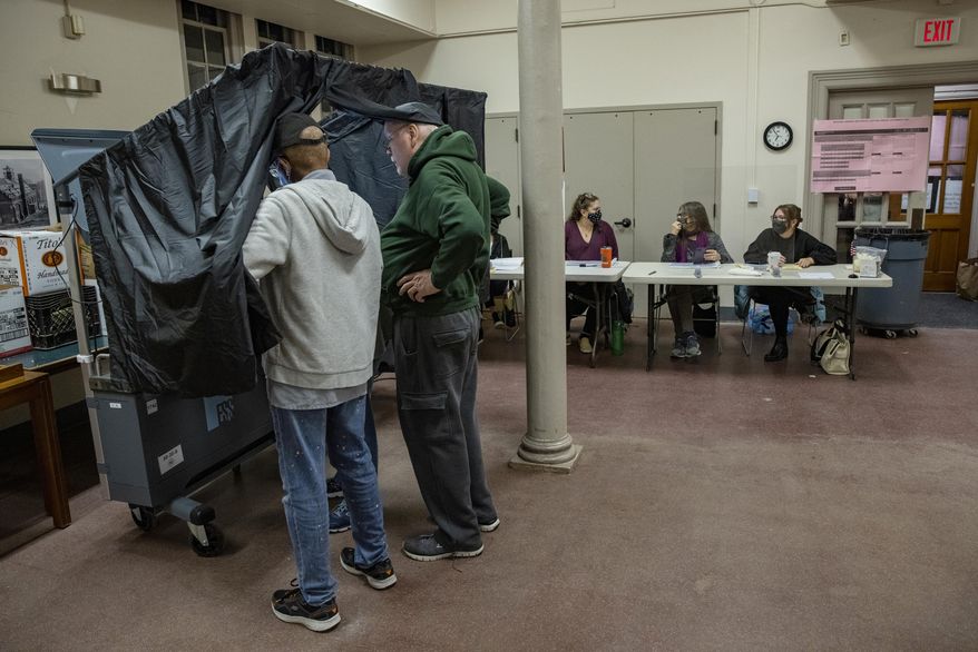 Poll workers prepare the voting machines for the start of voting on Election Day at Falls of Schuylkill Branch of Free Library in Philadelphia, Tuesday, Nov. 2, 2021. (Alejandro A. Alvarez/The Philadelphia Inquirer via AP)