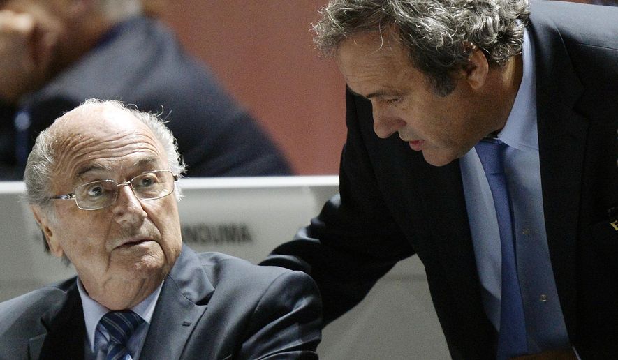 FIFA President Sepp Blatter, left, and UEFA President Michel Platini are engaged in conversation during the 65th FIFA Congress held at the Hallenstadion in Zurich, Switzerland, on Friday, May 29, 2015. Swiss prosecutors have charged former FIFA officials Sepp Blatter and Michel Platini with fraud and other offenses. (Walter Bieri/Keystone via AP) **FILE**