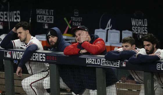 Members of the Atlanta Braves watch during the ninth inning in Game 5 of baseball&#39;s World Series between the Houston Astros and the Atlanta Braves Monday, Nov. 1, 2021, in Atlanta. The Astros won 9-5. The Braves lead the series 3-2 games. (AP Photo/Ashley Landis) **FILE**